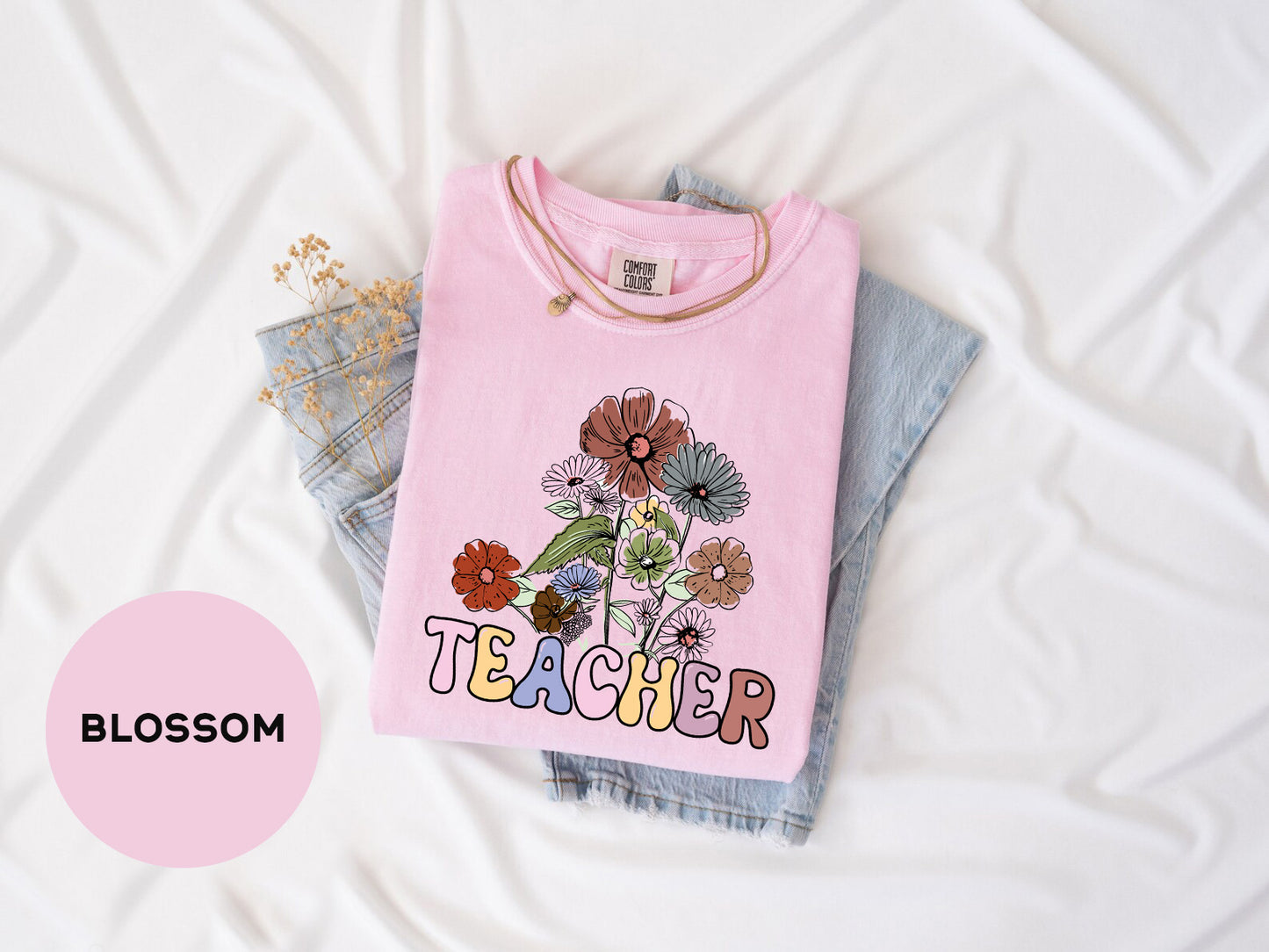 a pink t - shirt with a picture of a flower on it