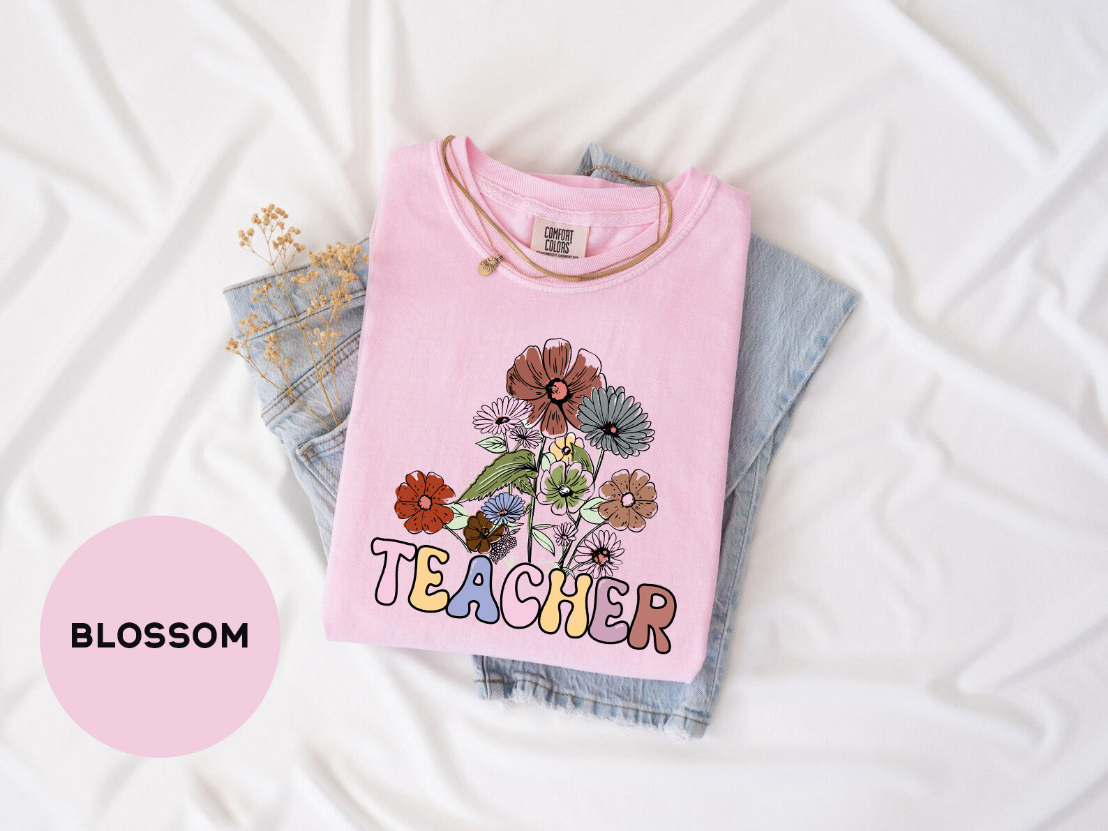 a pink t - shirt with a picture of a flower on it