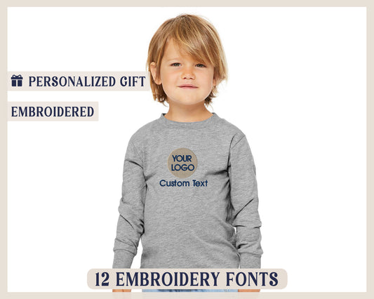 a young boy wearing a gray shirt with the words your logo on it