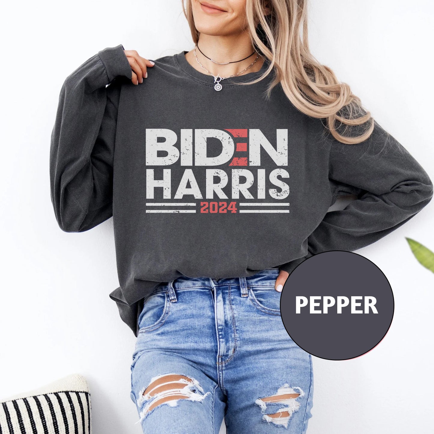 a woman wearing a sweatshirt that says biden harris