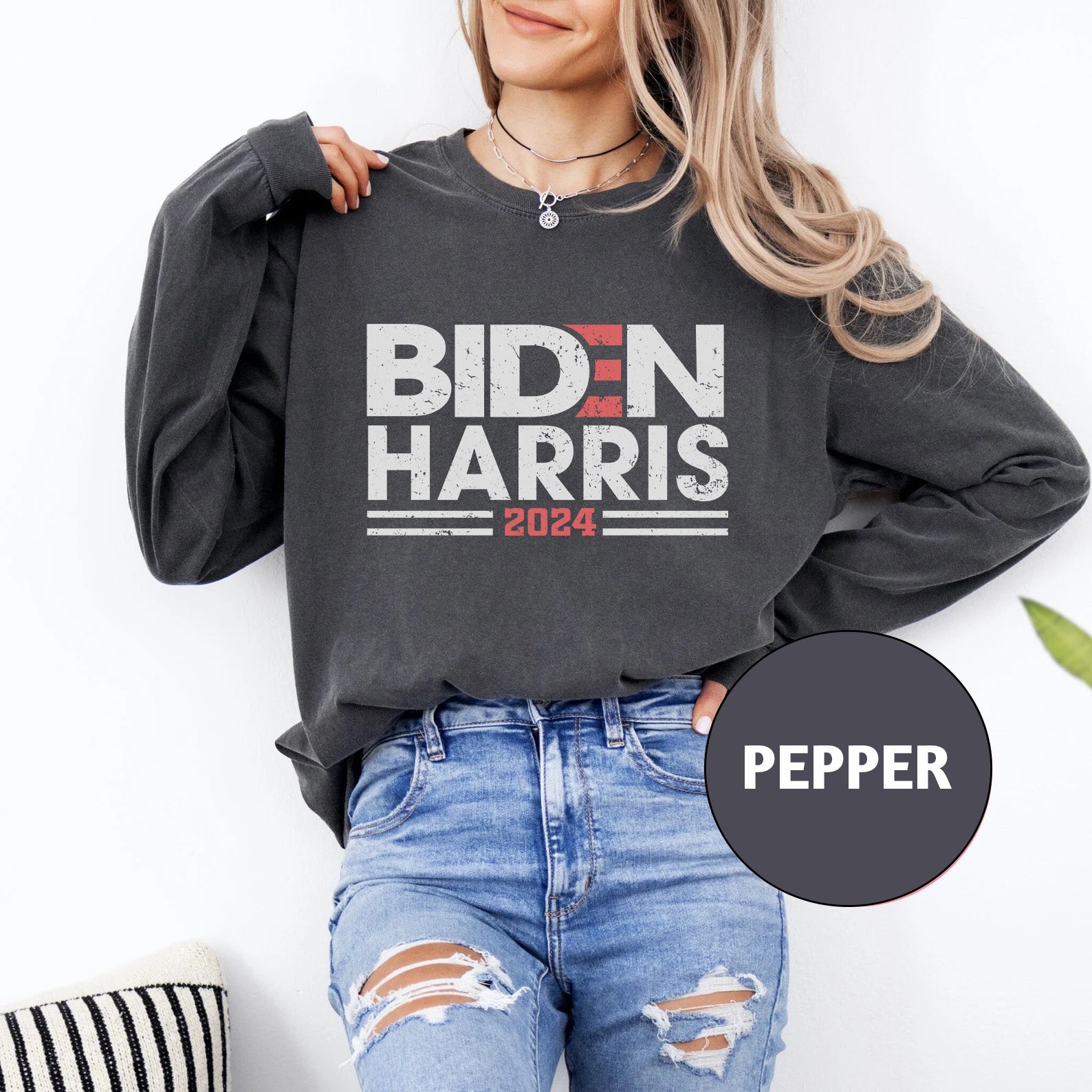 a woman wearing a sweatshirt that says biden harris