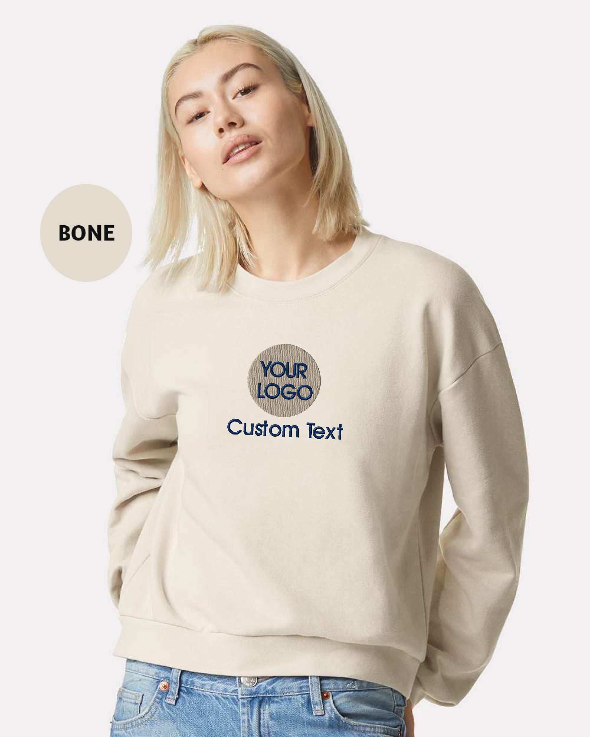 a woman wearing a white sweatshirt with the words your logo on it