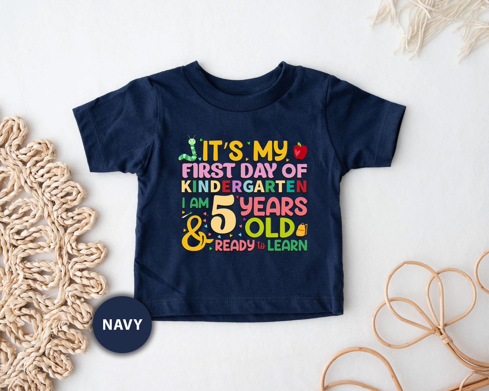 a t - shirt that says it's my first day of school and five