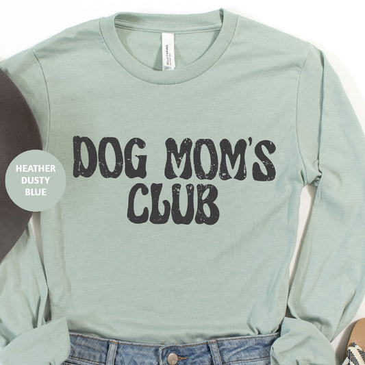 a shirt that says dog mom's club next to a record