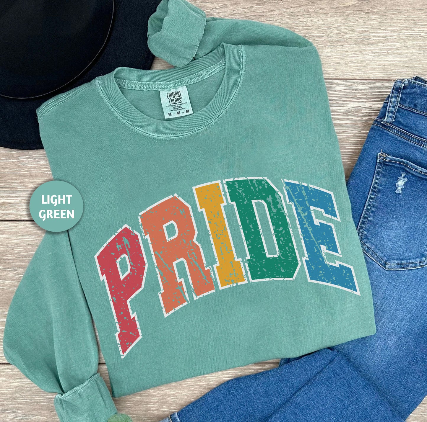 a green shirt with the word pride printed on it