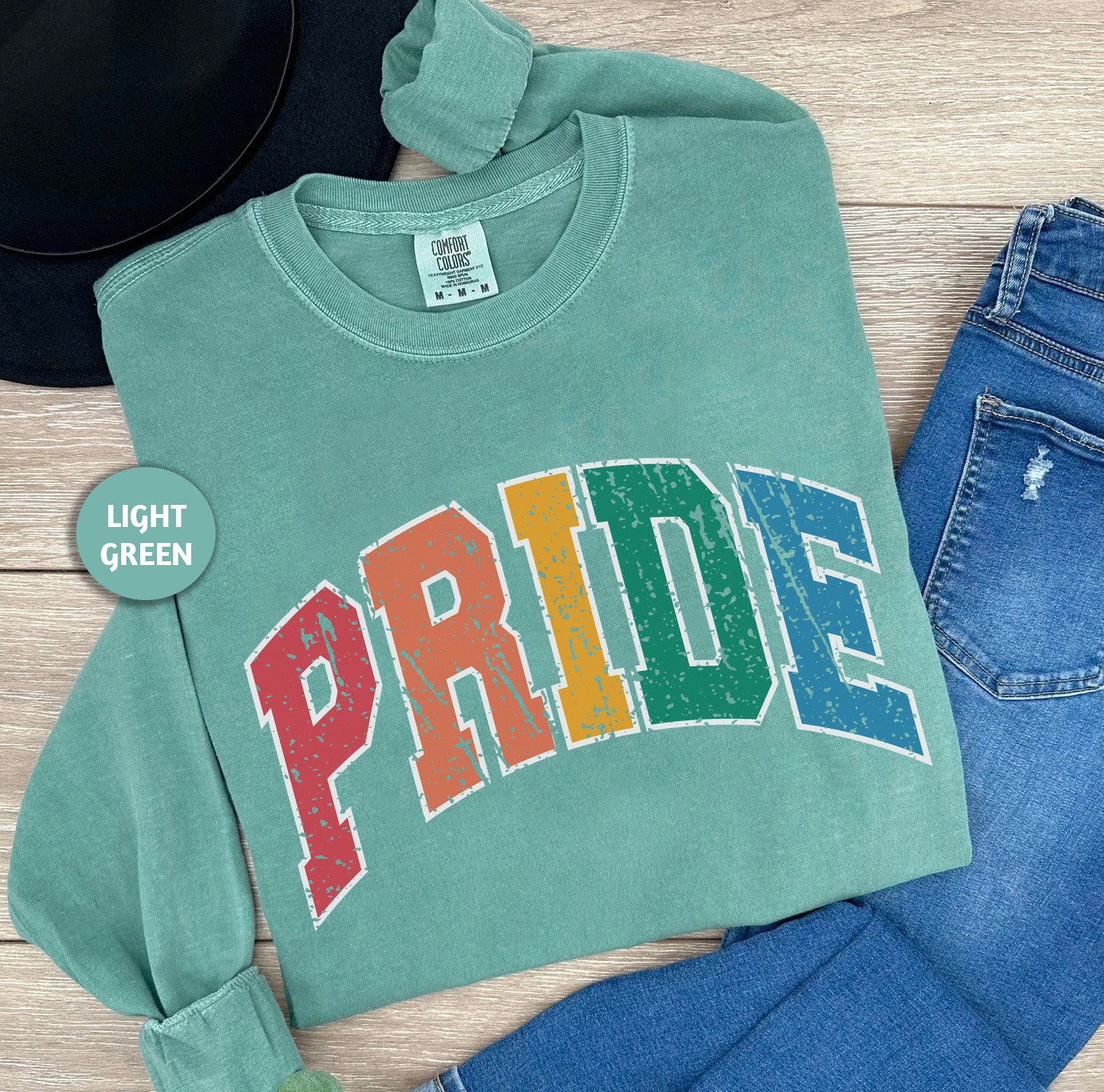 a green shirt with the word pride printed on it