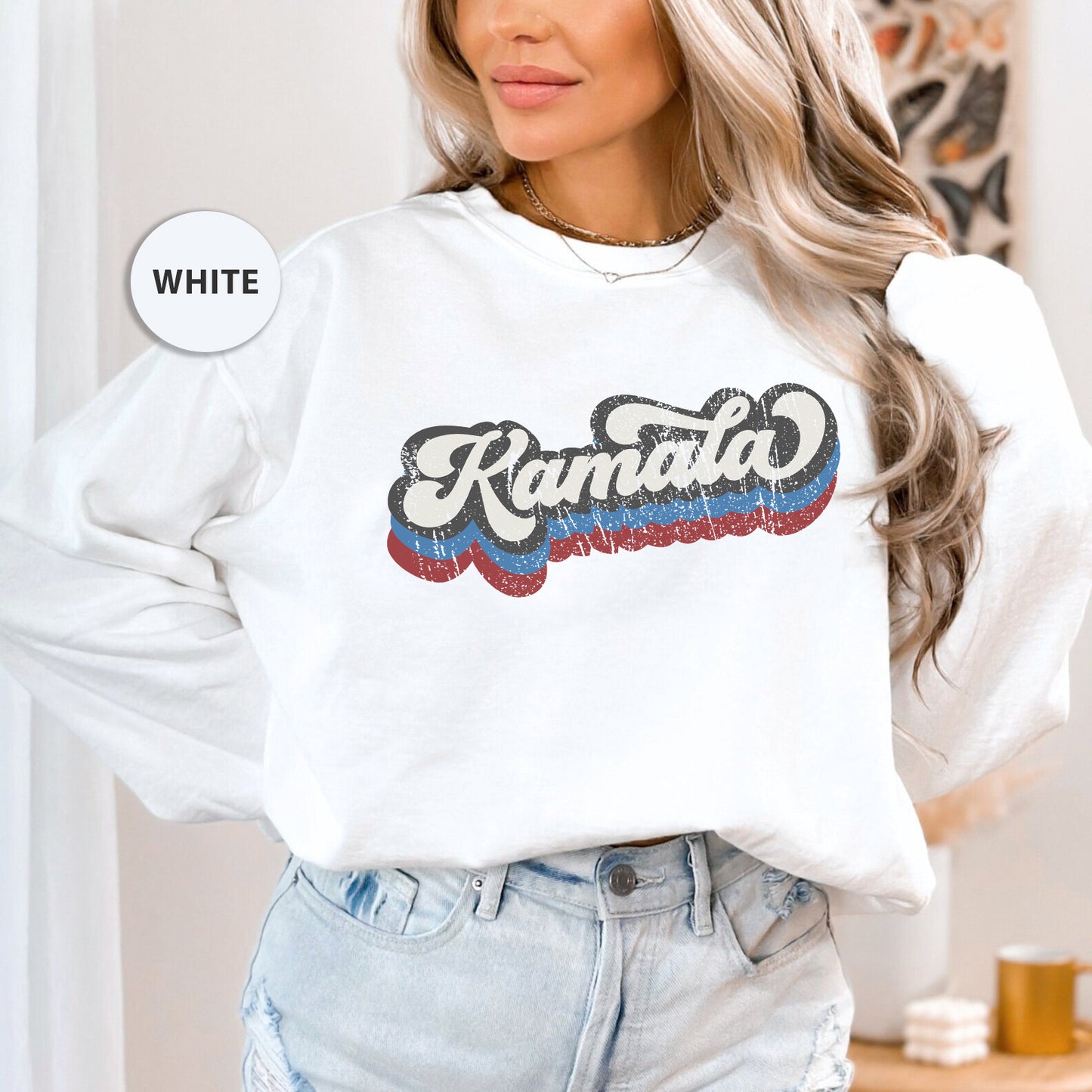 a woman wearing a white sweatshirt and jeans