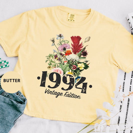 a yellow t - shirt with a picture of flowers on it