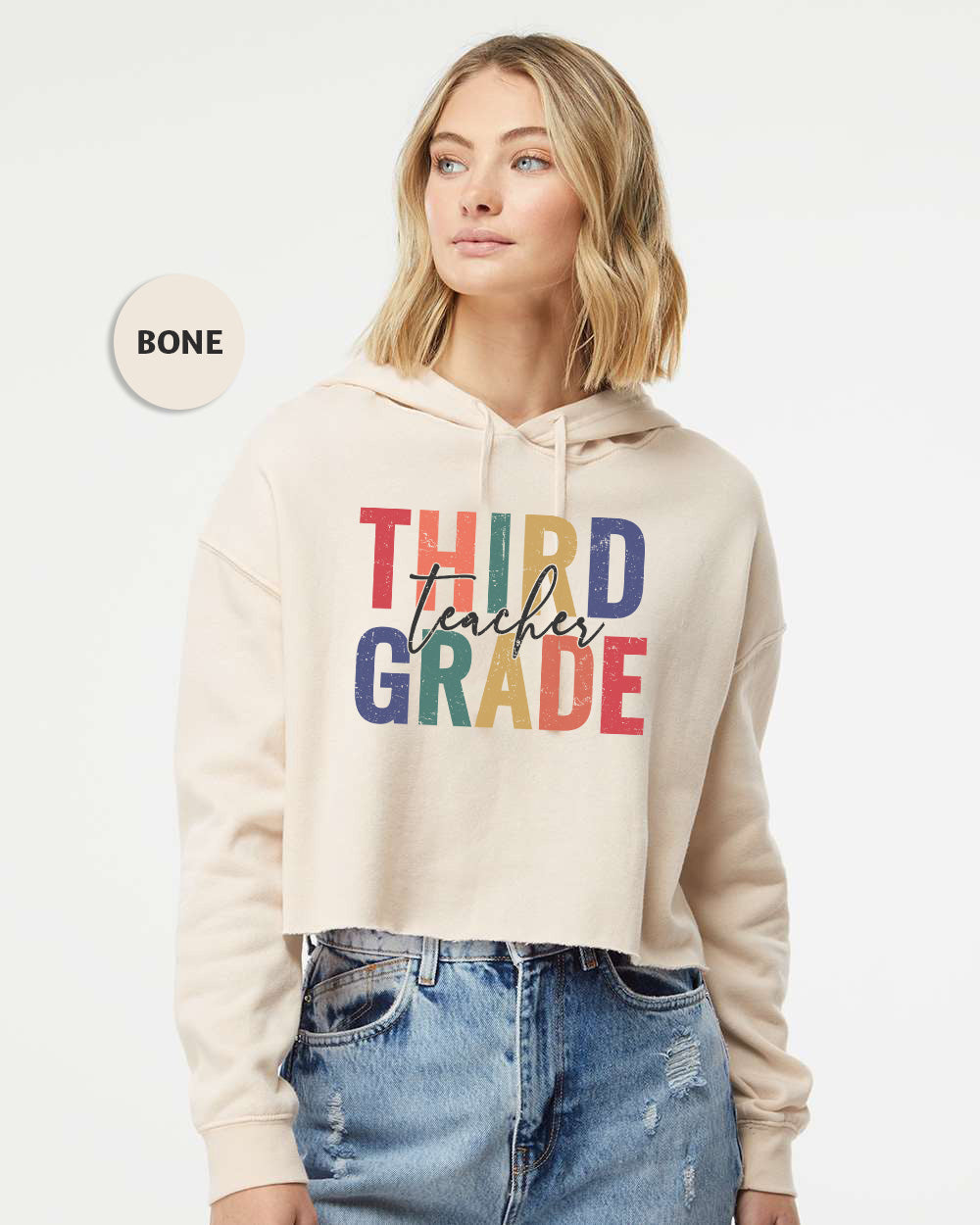 a woman wearing a sweatshirt that says third grade