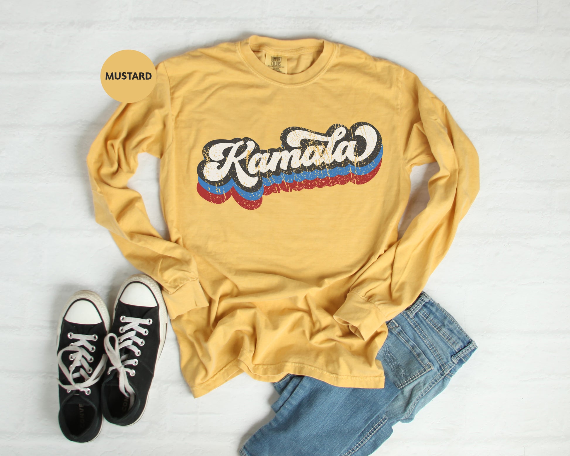 a yellow shirt with the word kanata on it and a pair of black sneakers
