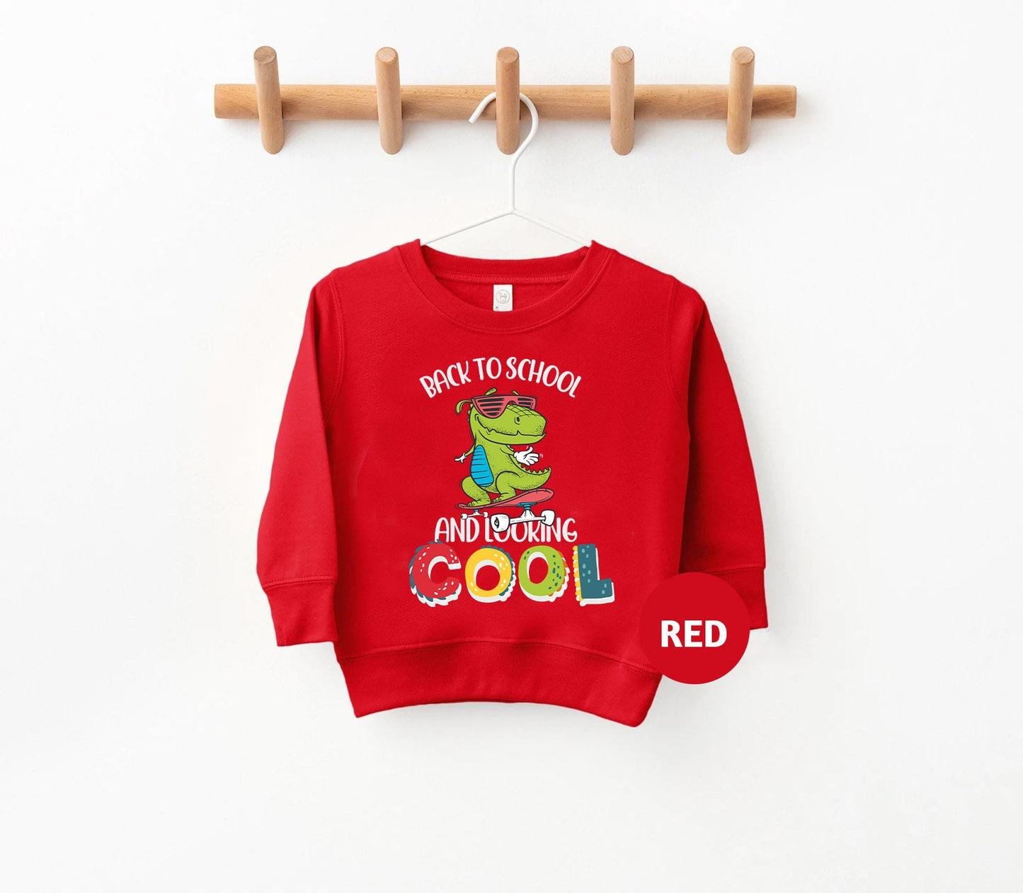 a child's sweater with a picture of a toddler wearing a red shirt