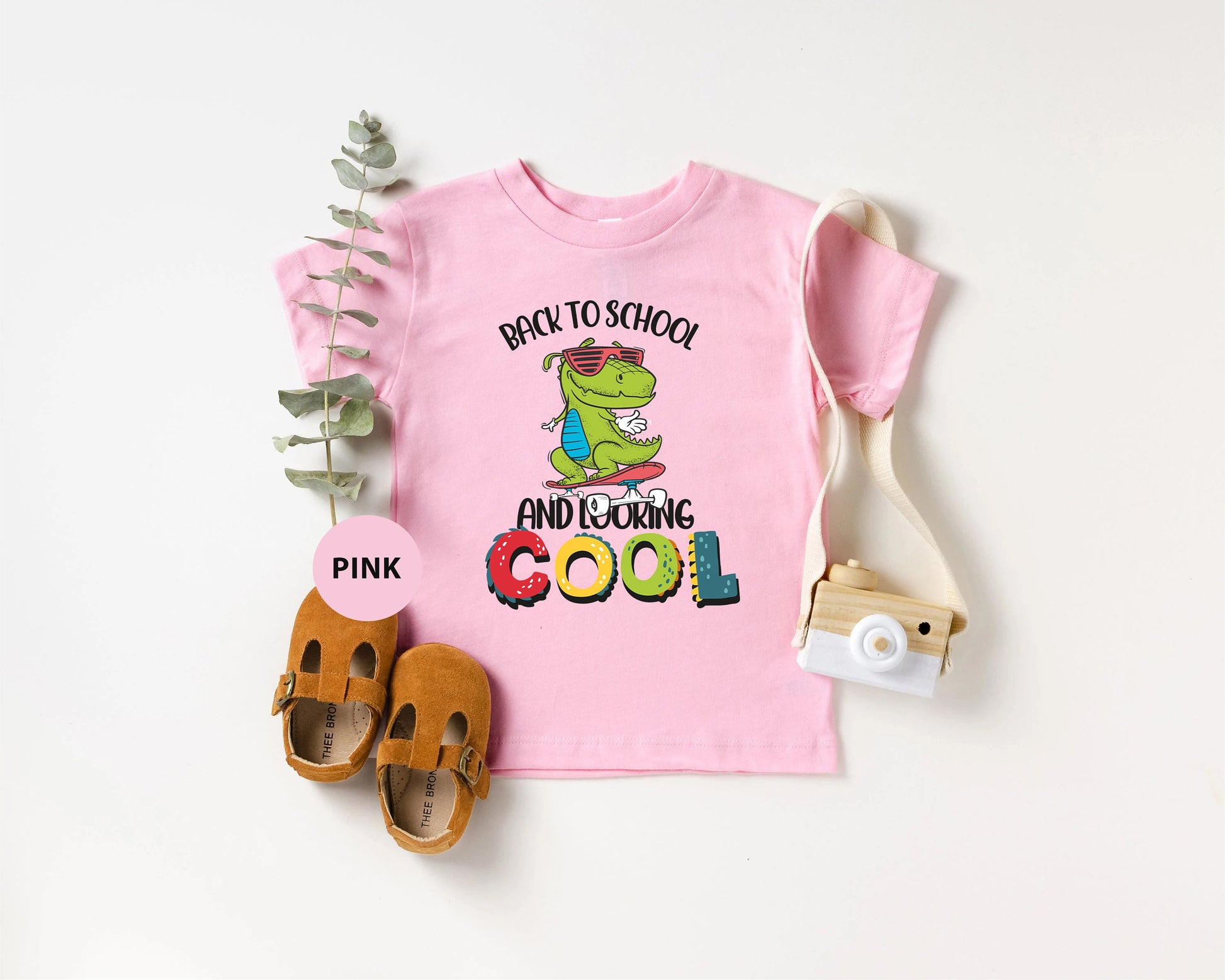 a pink shirt with the words back to school and a pair of sandals