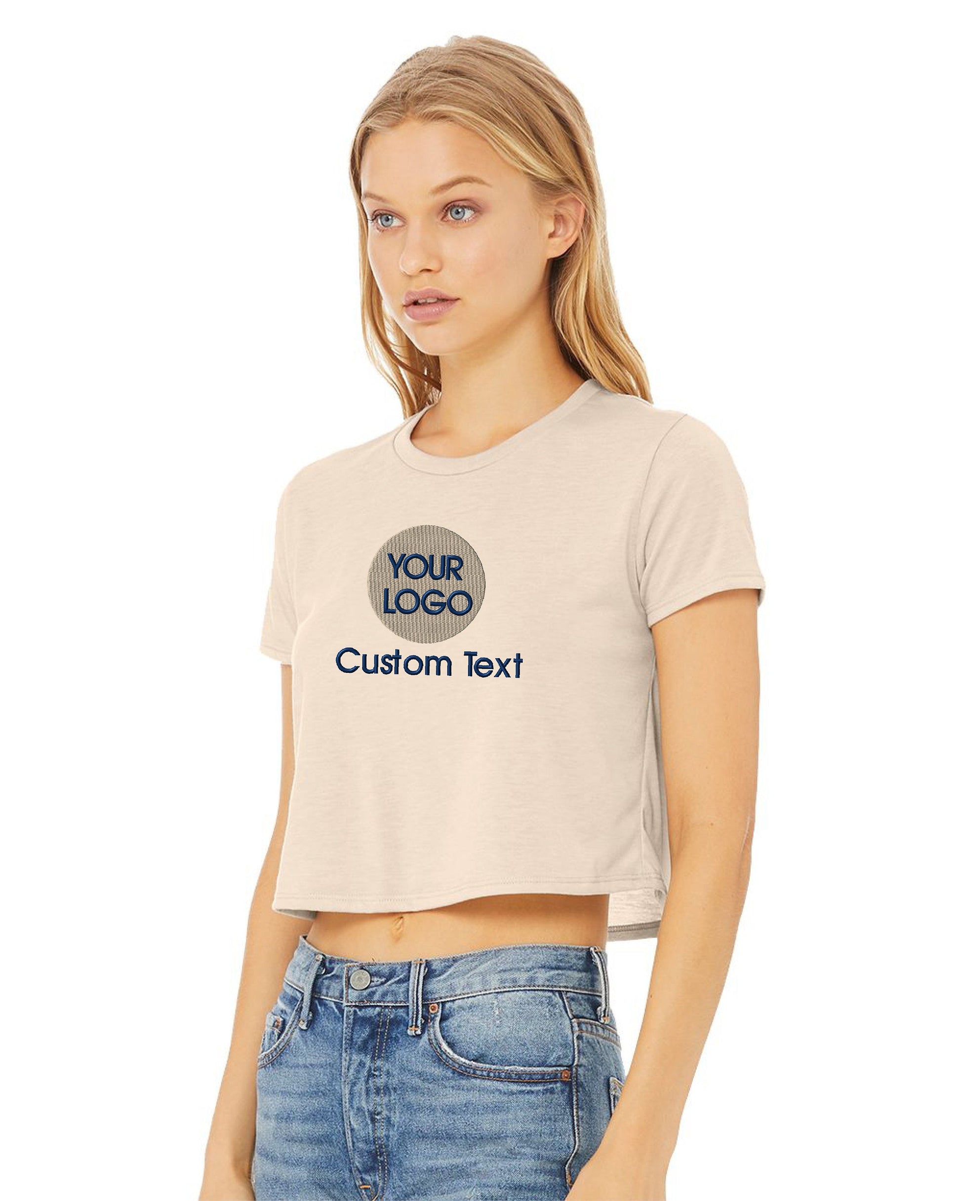 a woman wearing a cropped crop top and jeans