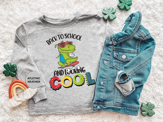 a shirt that says back to school and going cool next to a pair of jeans