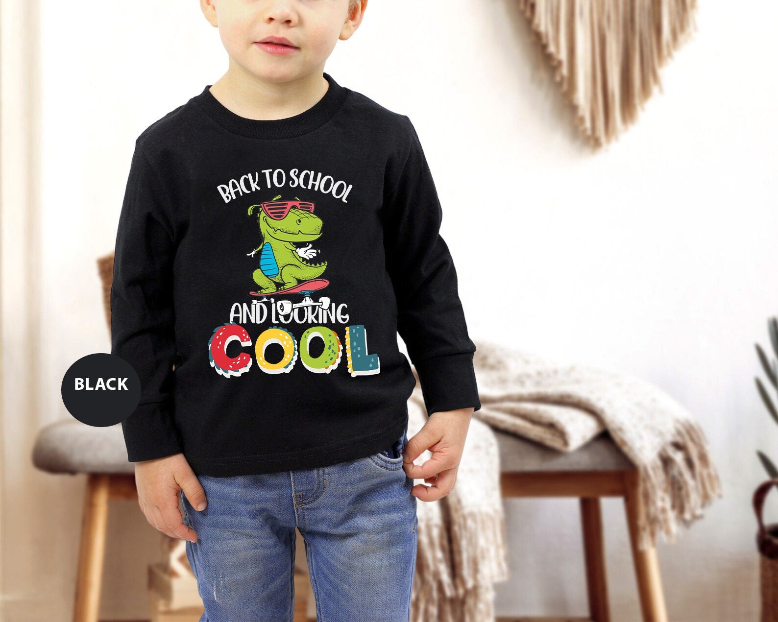 a young boy standing in a room wearing a black shirt