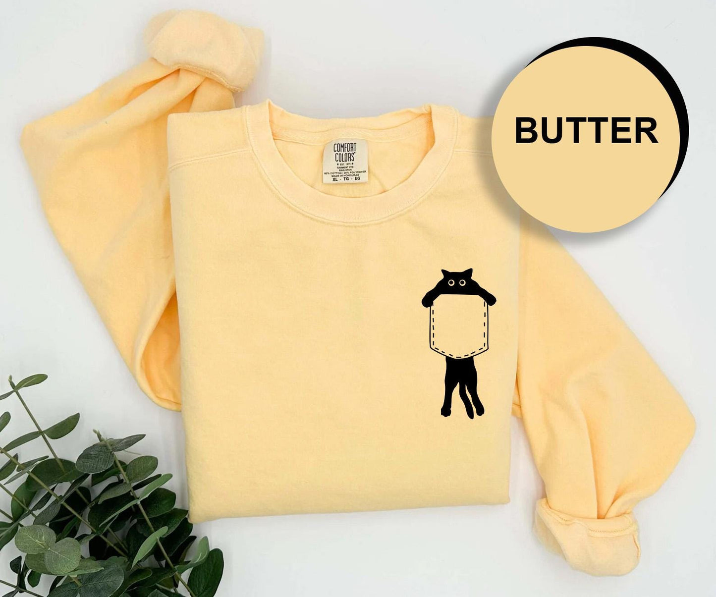 a yellow shirt with a black cat on it