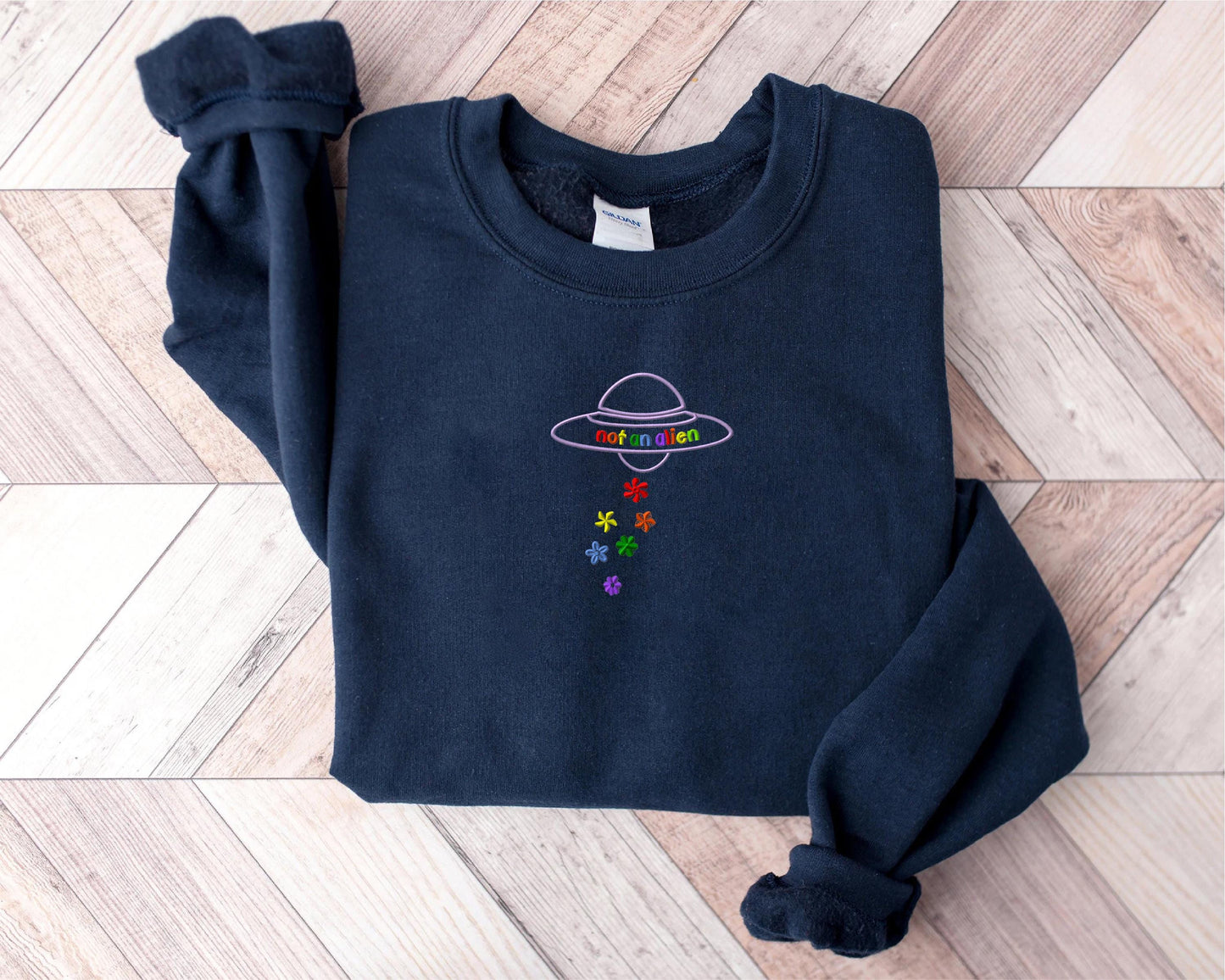 a blue sweater with a picture of an alien on it