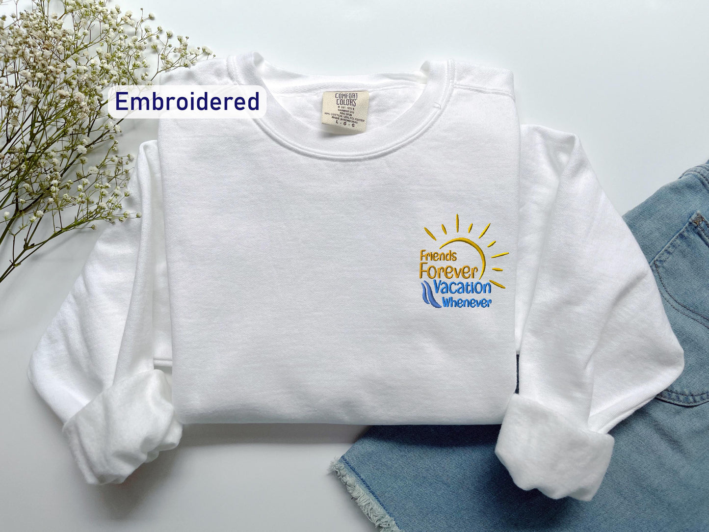 a white shirt with a yellow sun on it