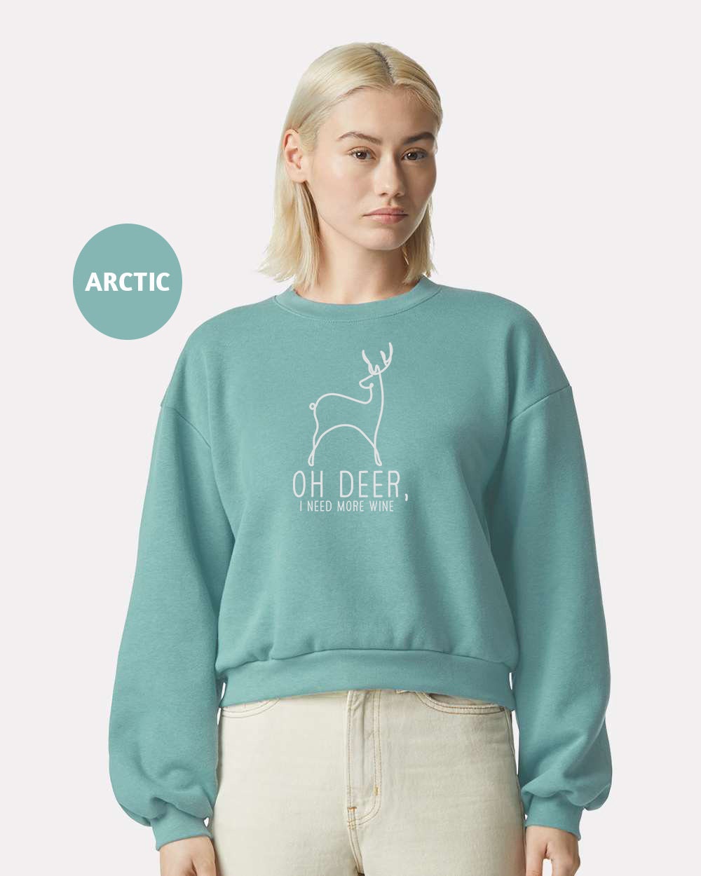 a woman wearing a sweatshirt with a deer on it