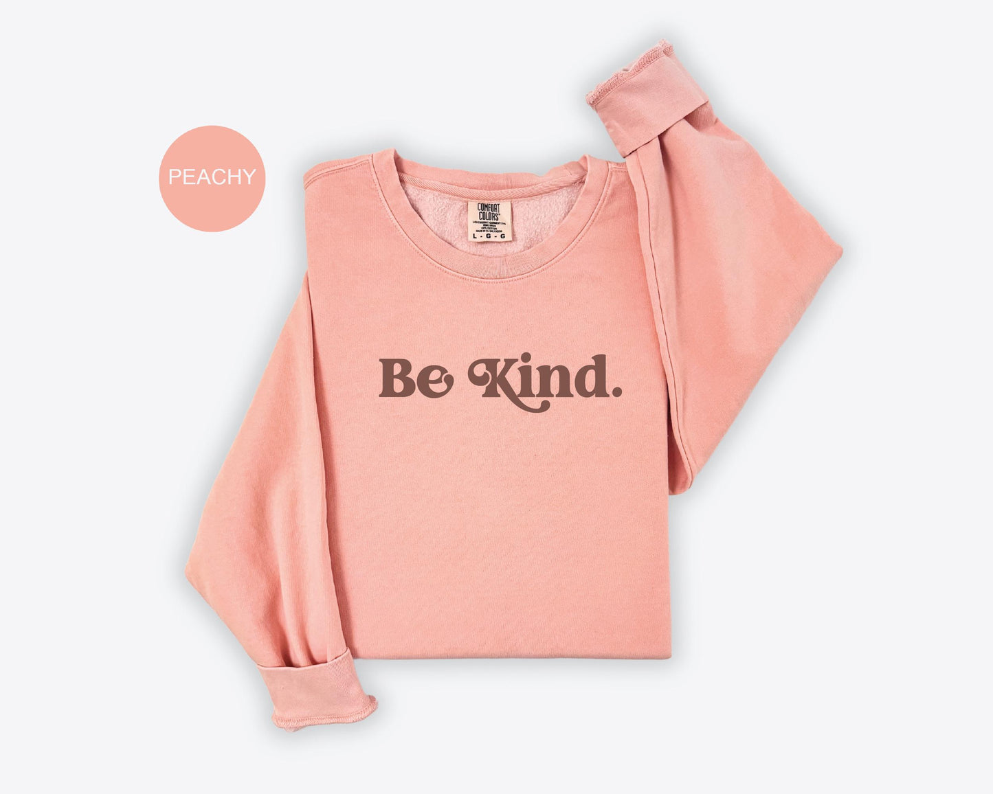 a pink shirt with the words be kind printed on it