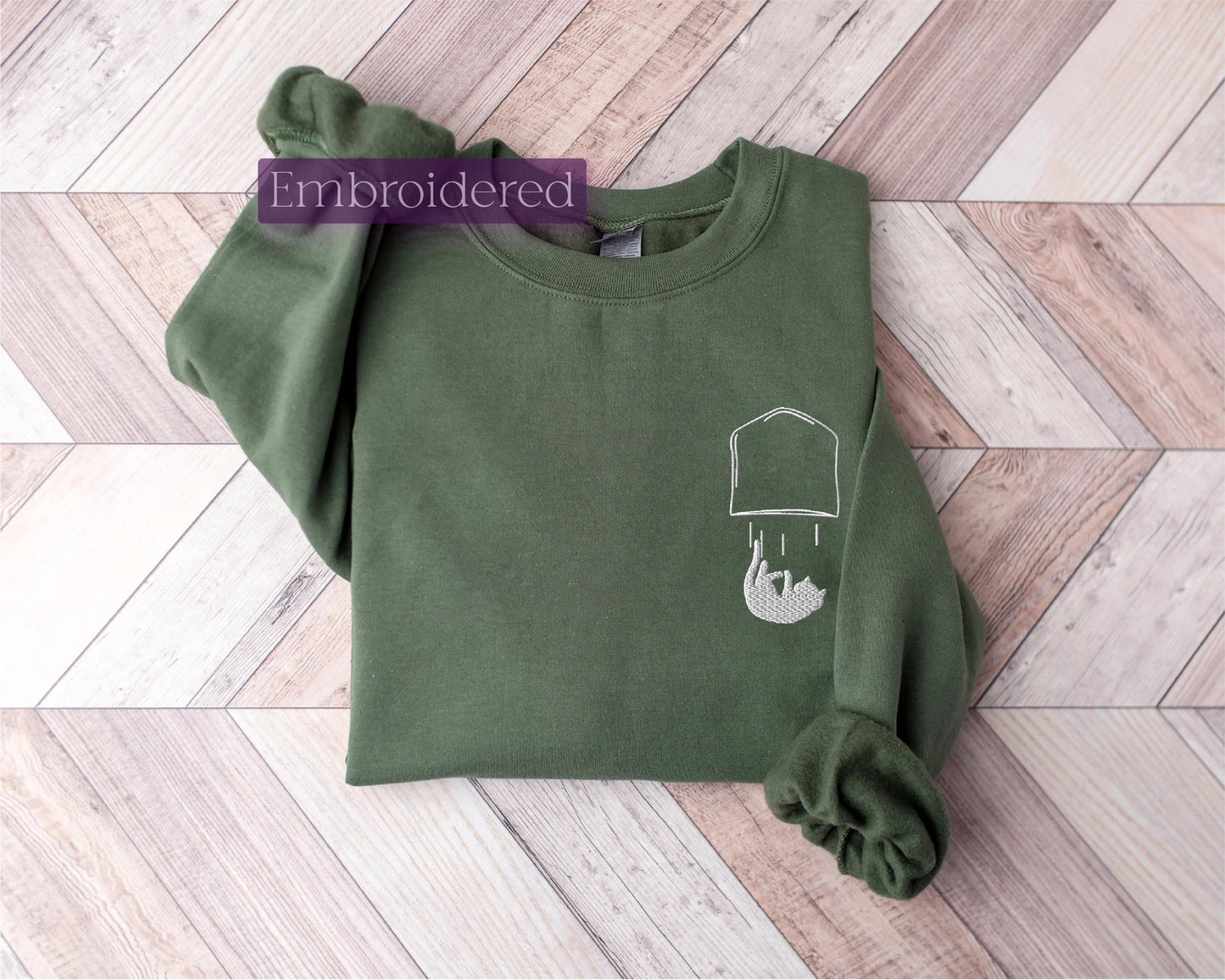 a green sweatshirt with a picture of a man's head on it