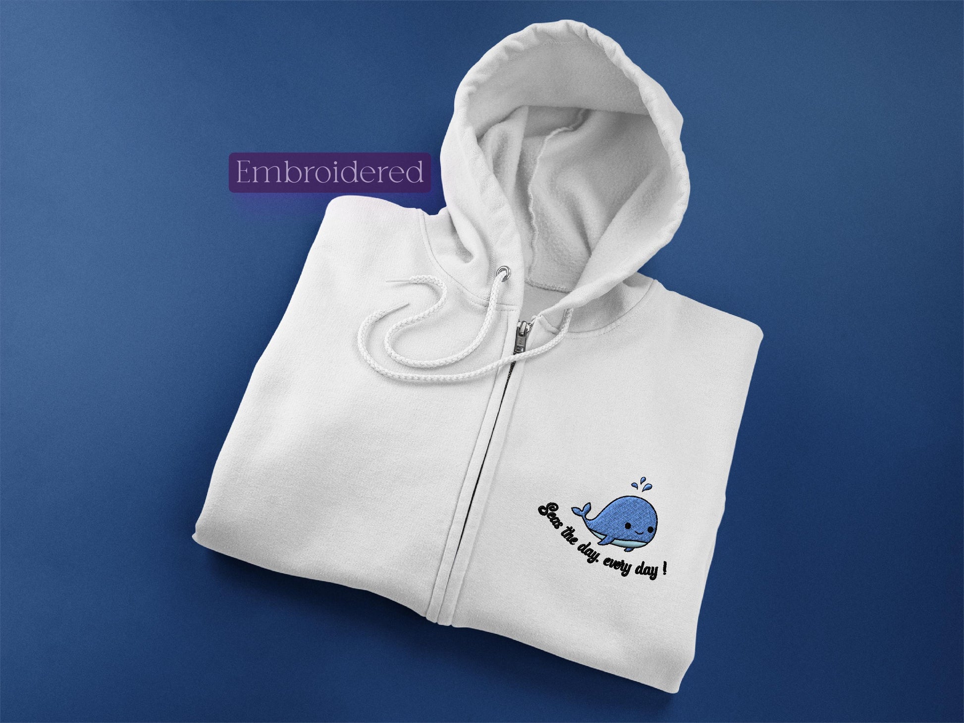 a white hoodie with a blue whale on it
