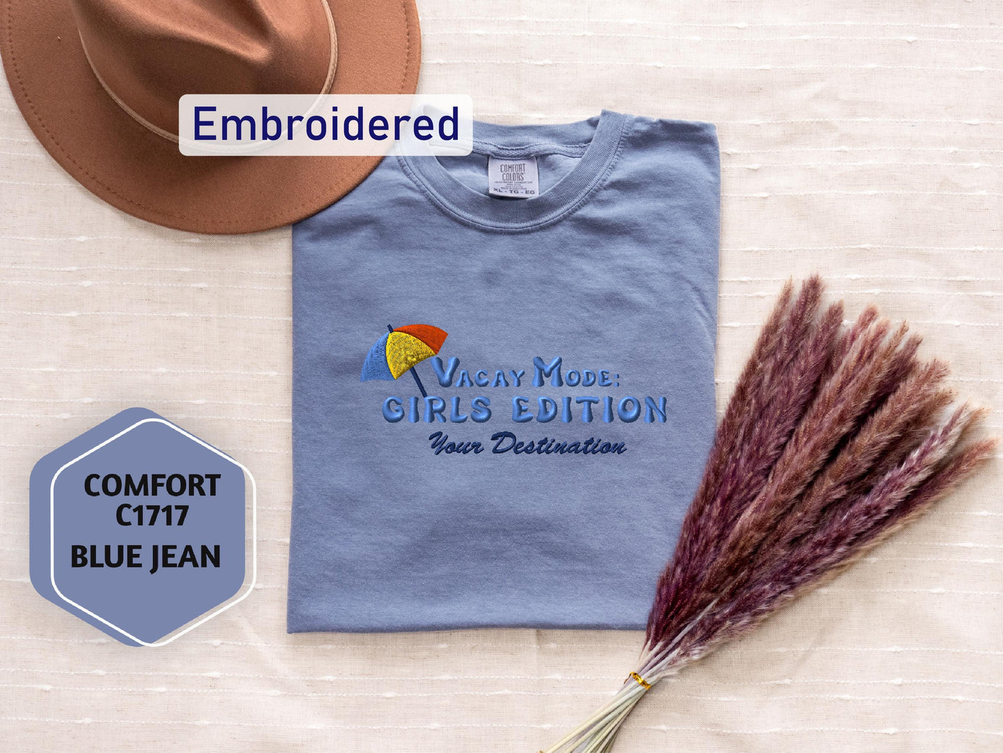a hat, t - shirt, and broom on a table