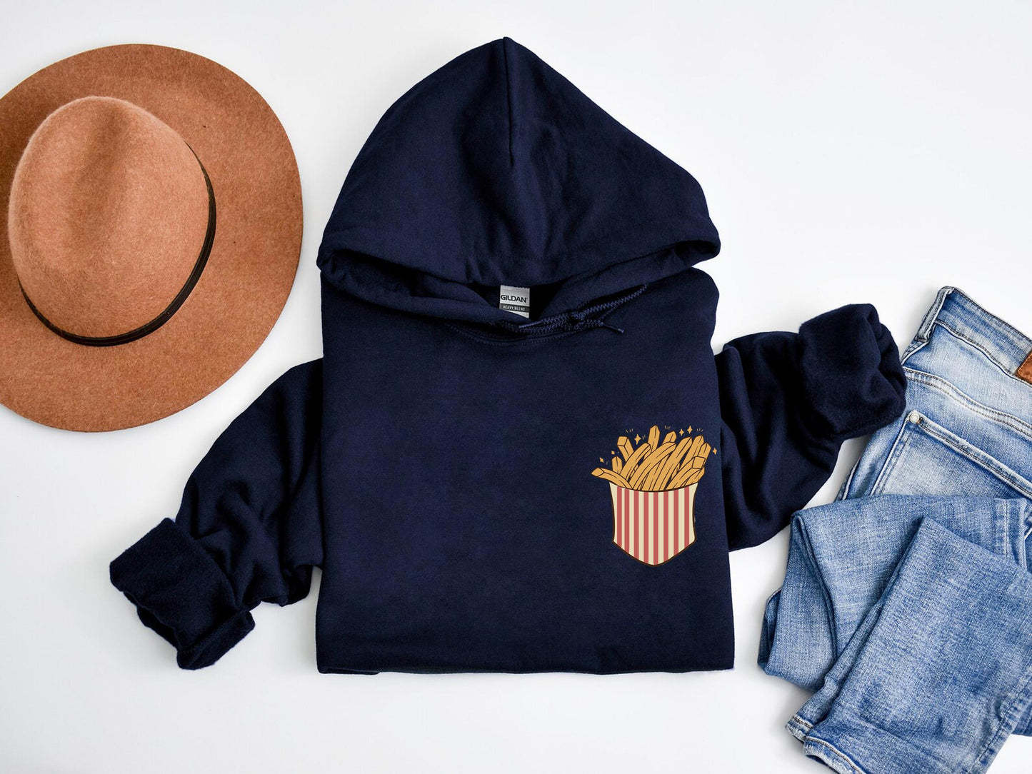 a hoodie with french fries on it next to a pair of jeans and a