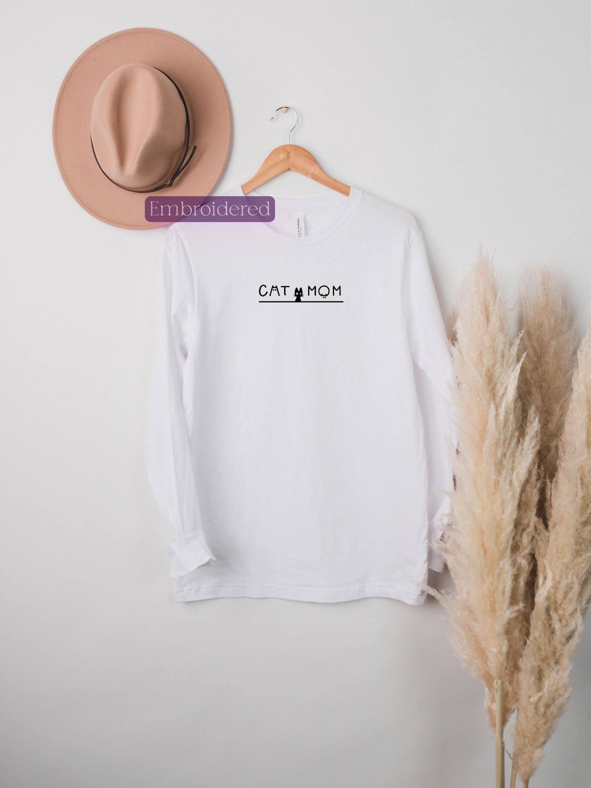a hat and a t - shirt hanging on a wall