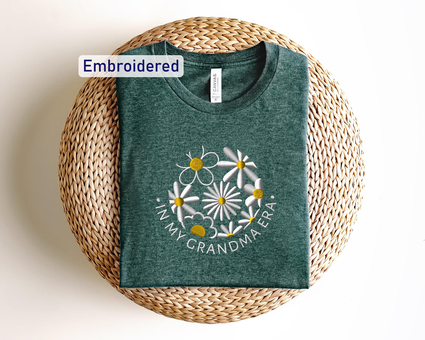 a green t - shirt with white daisies on it