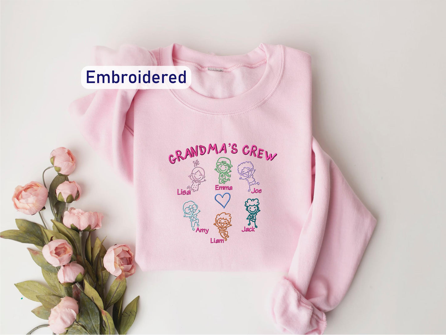 a pink sweater with the words grandma's crew on it