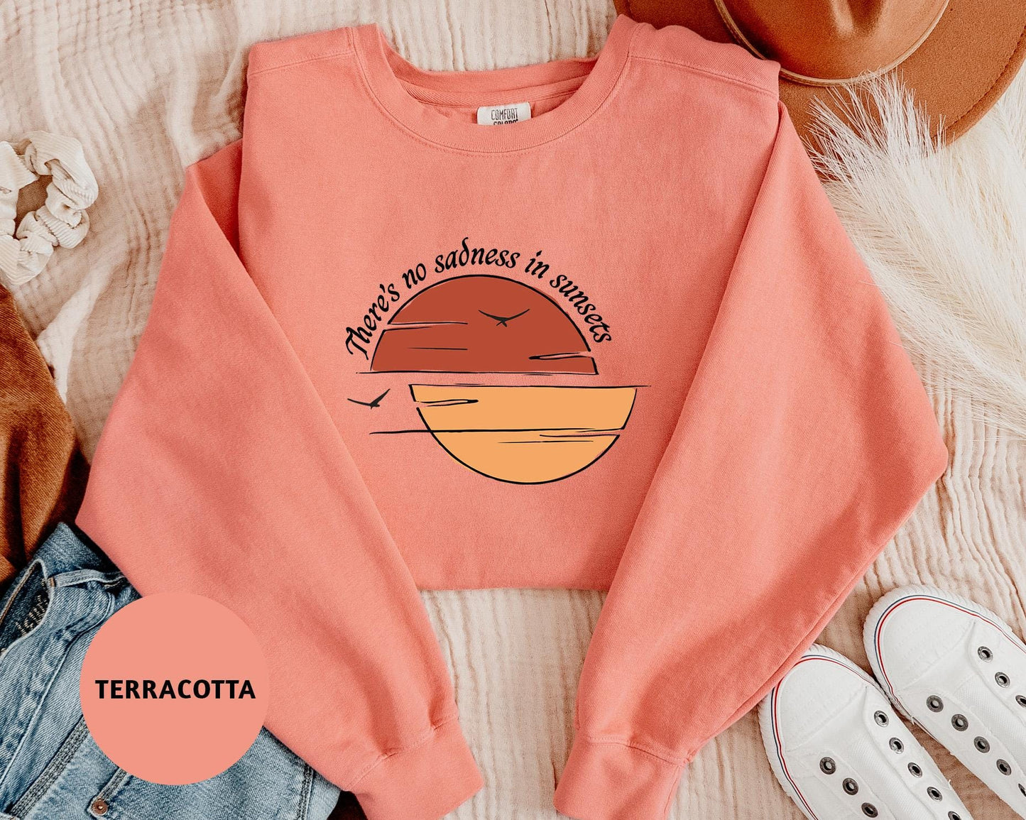 a pink shirt with a sunset on it