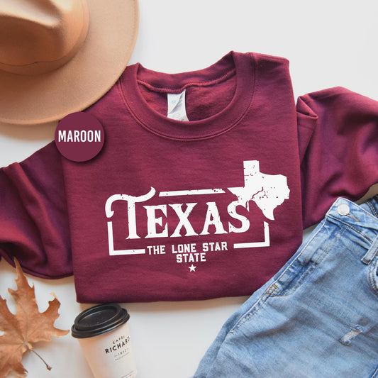 a maroon texas t - shirt with the lone star state on it