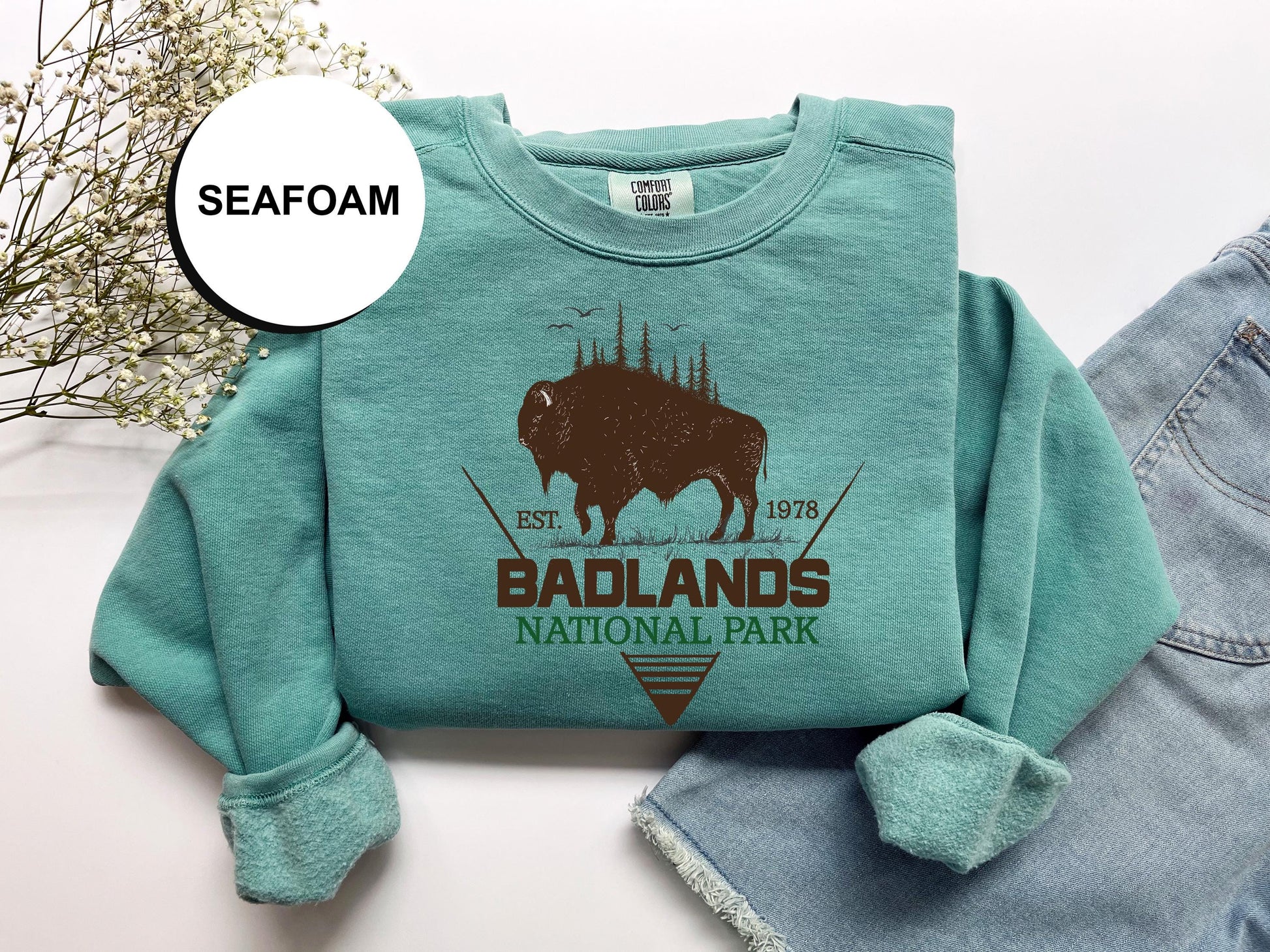 a t - shirt with a bison on it and a pair of jeans