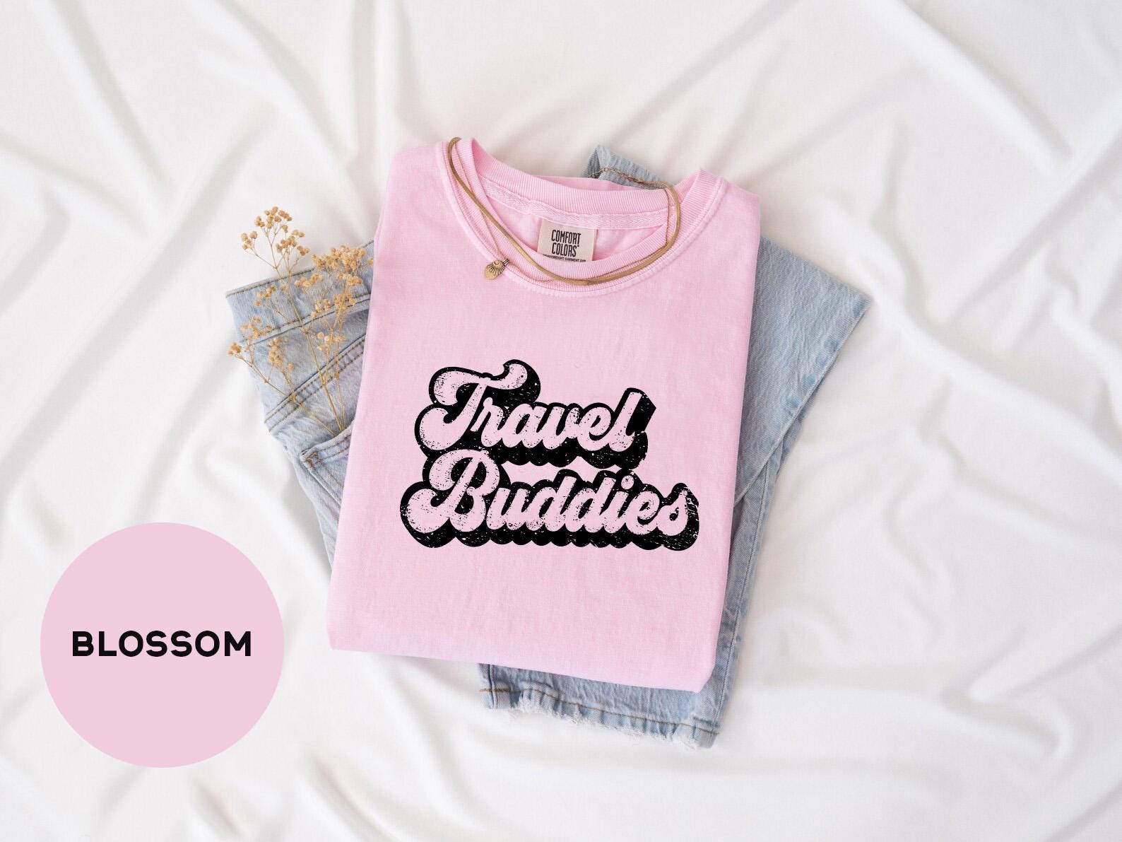 a pink shirt that says travel buddies on it