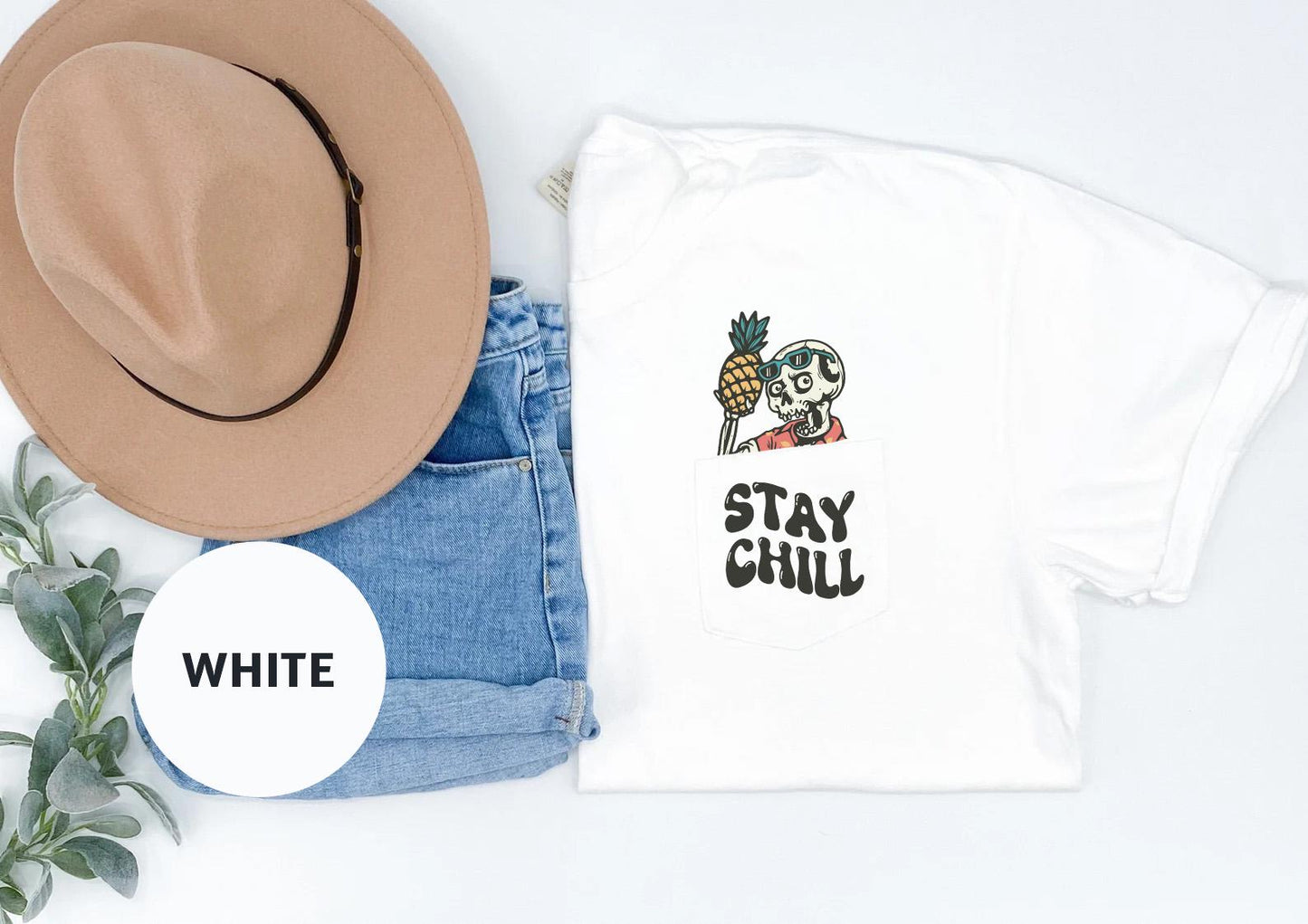 a t - shirt with a skull and a hat next to it