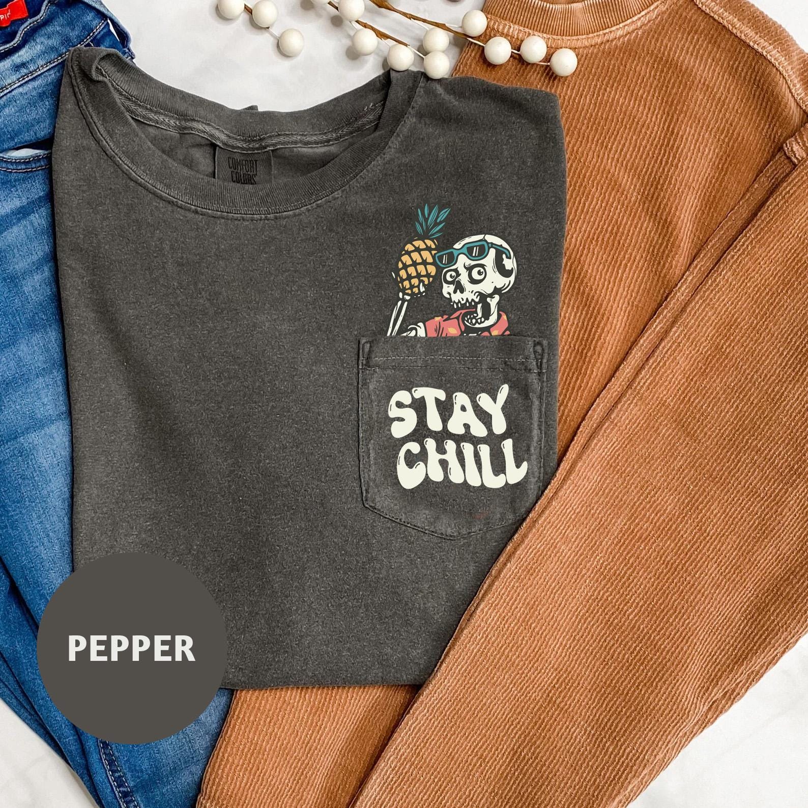 a black shirt with a skull and a pineapple on it