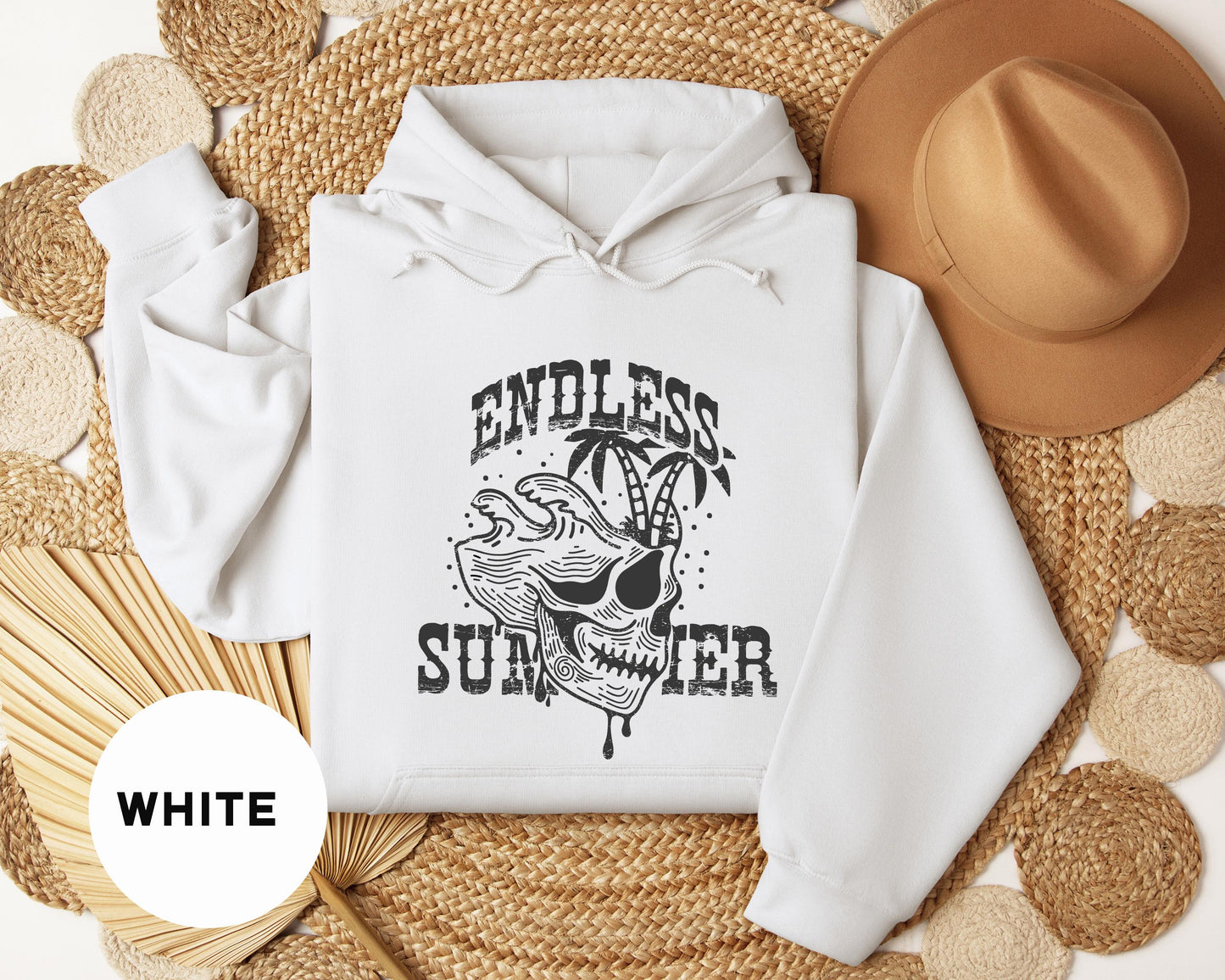 a white hoodie with an image of a skull on it