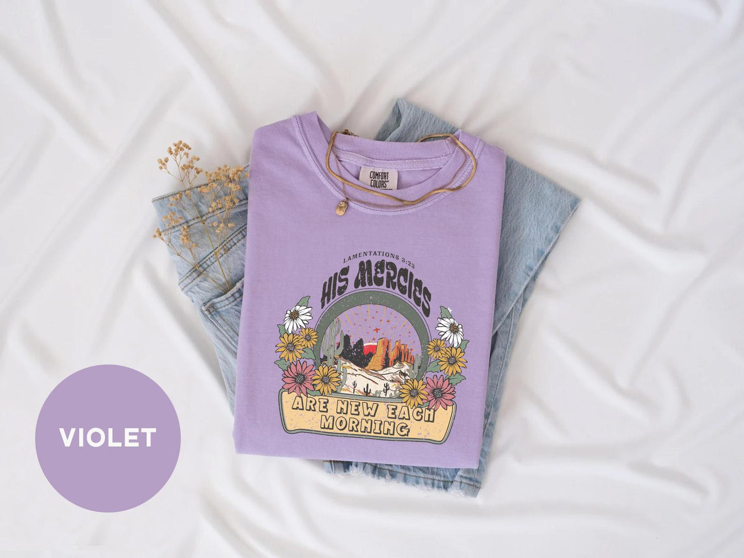 a purple shirt with a picture of a mountain and trees on it