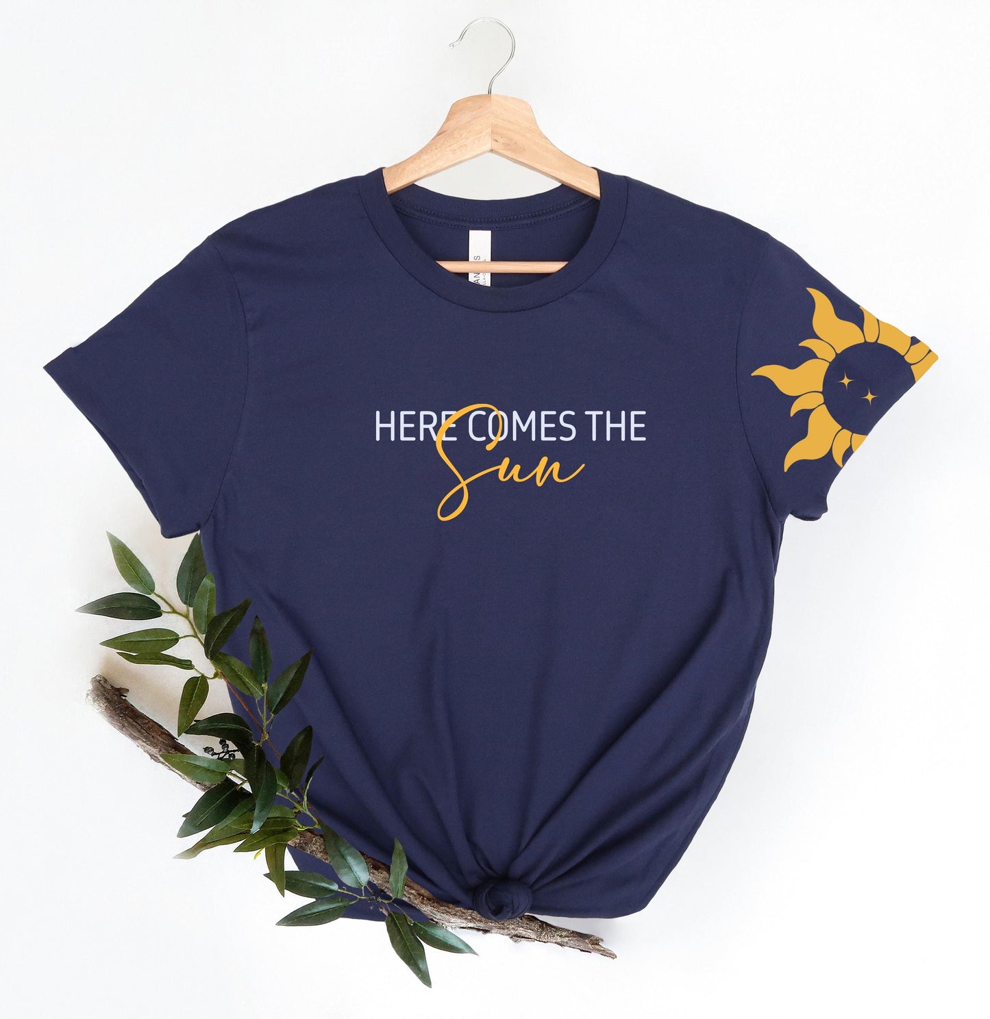 a t - shirt that says, here comes the sun