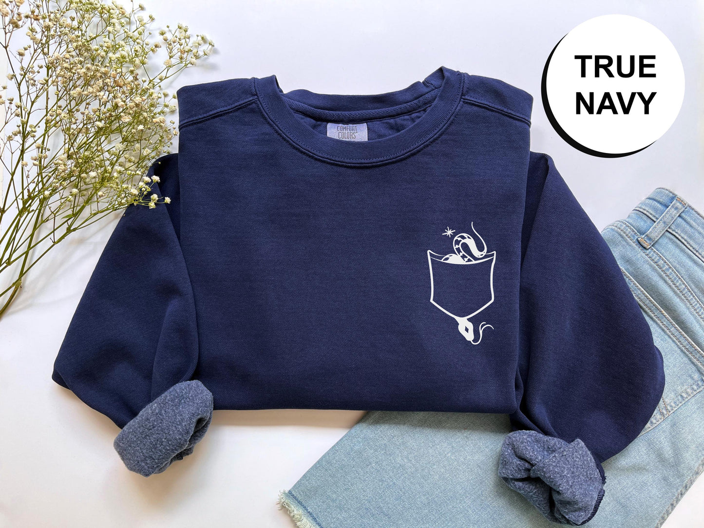 a pair of jeans and a sweatshirt with a picture of a woman in a pocket