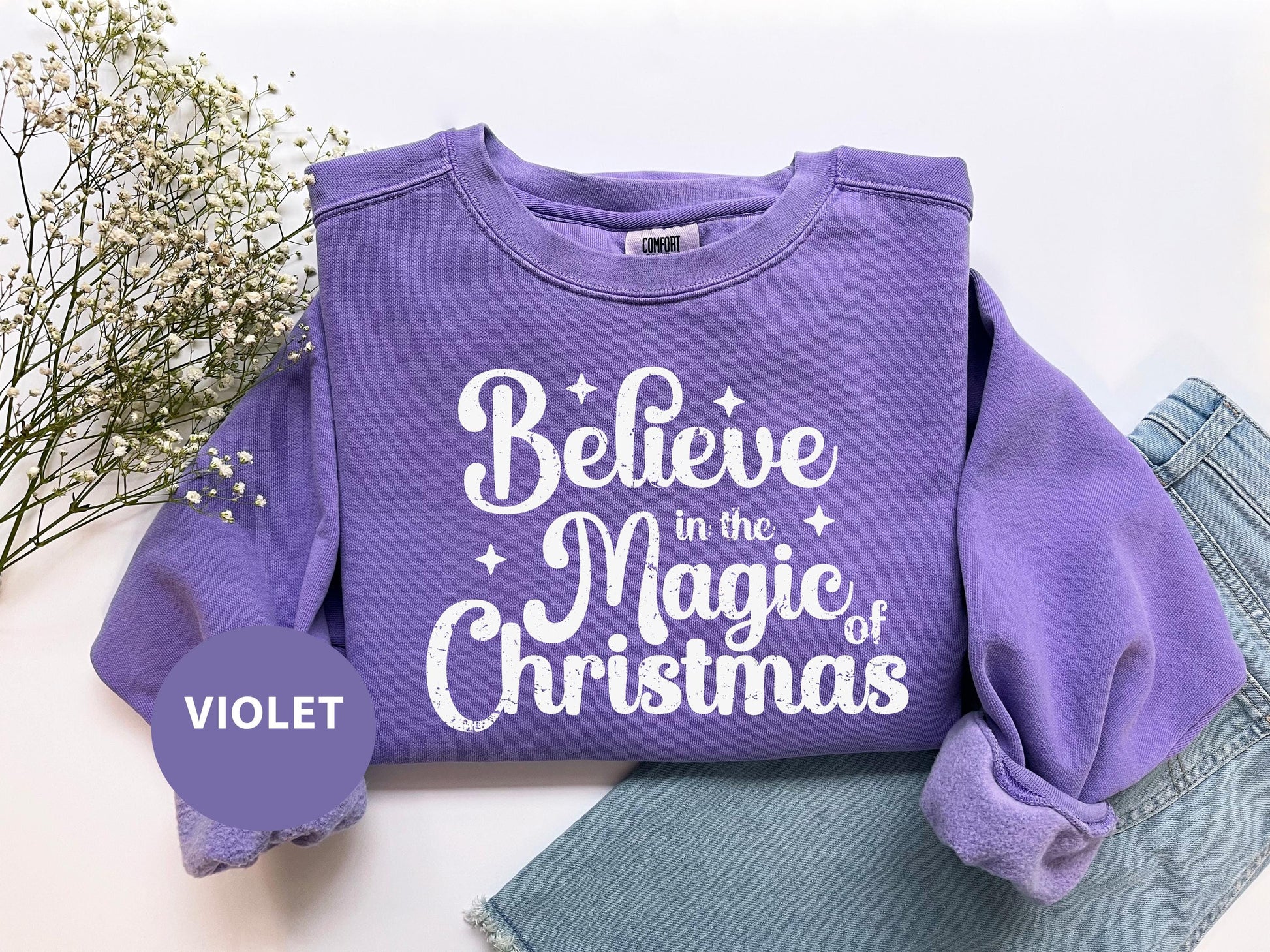a purple shirt that says believe in the magic of christmas