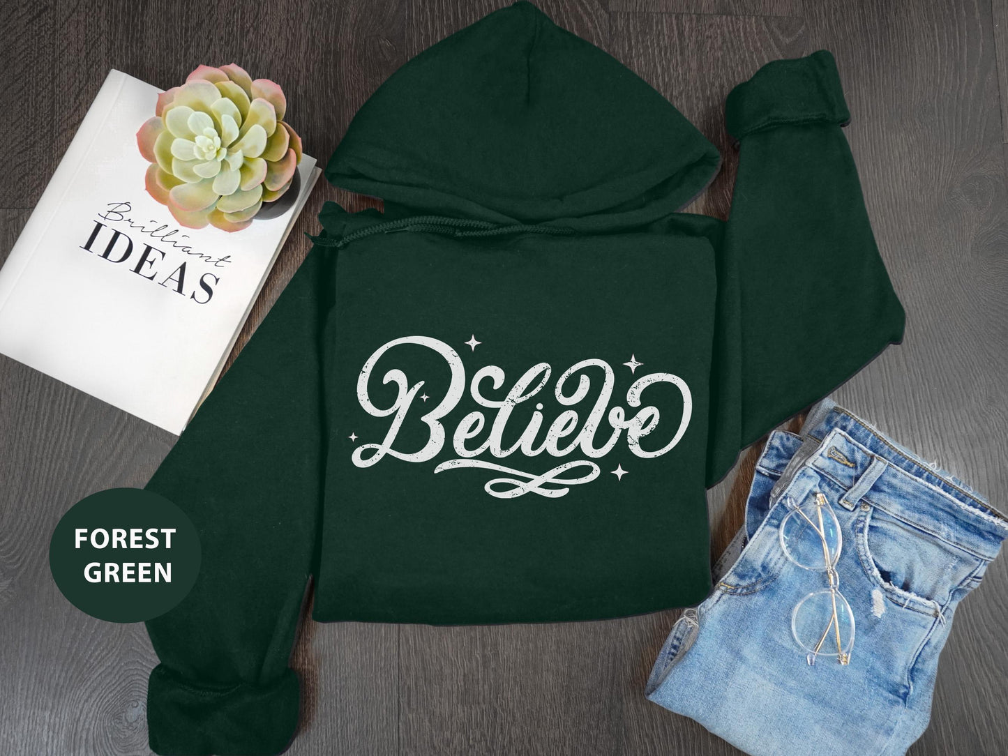 a green hoodie with the words believe on it
