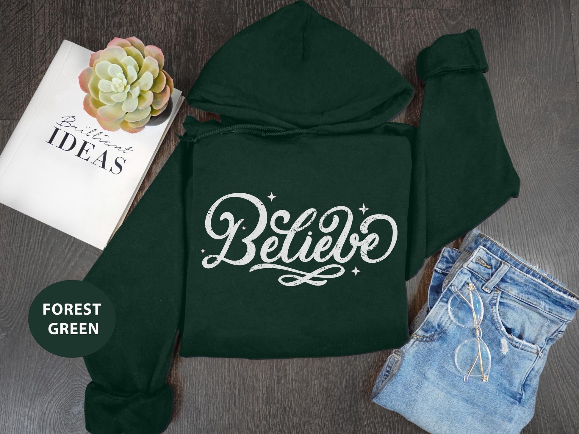 a green hoodie with the words believe on it