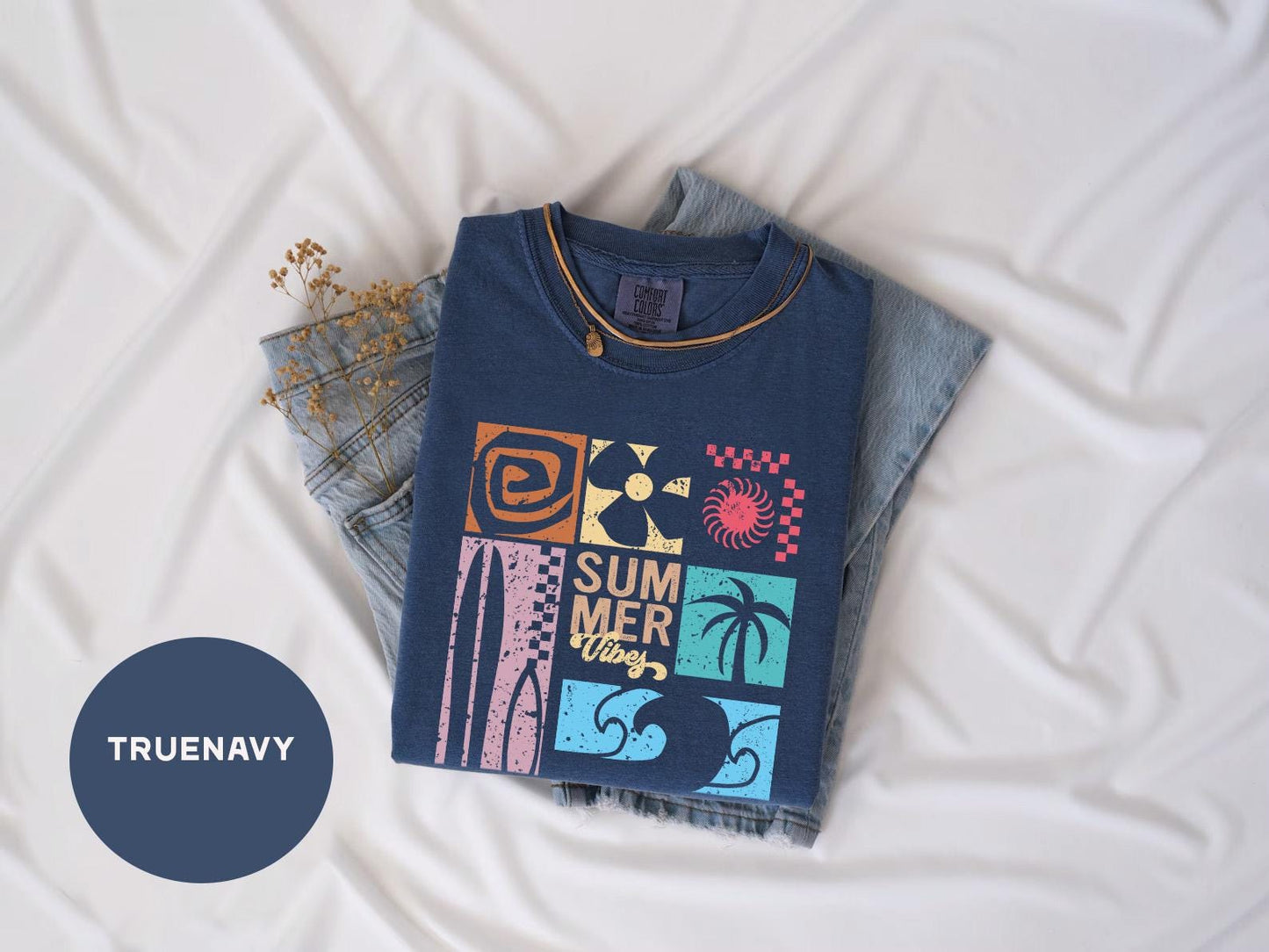 a blue t - shirt with a picture of a surfboard and palm trees on