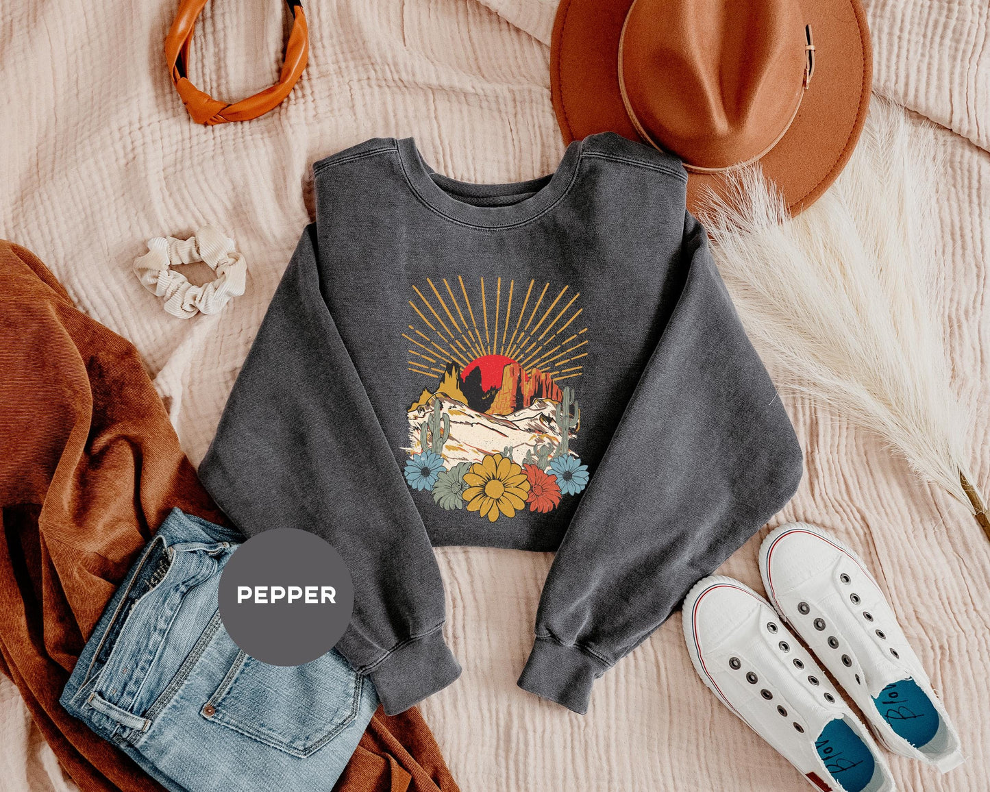 a sweater, jeans, hat, and a pair of slippers on a bed