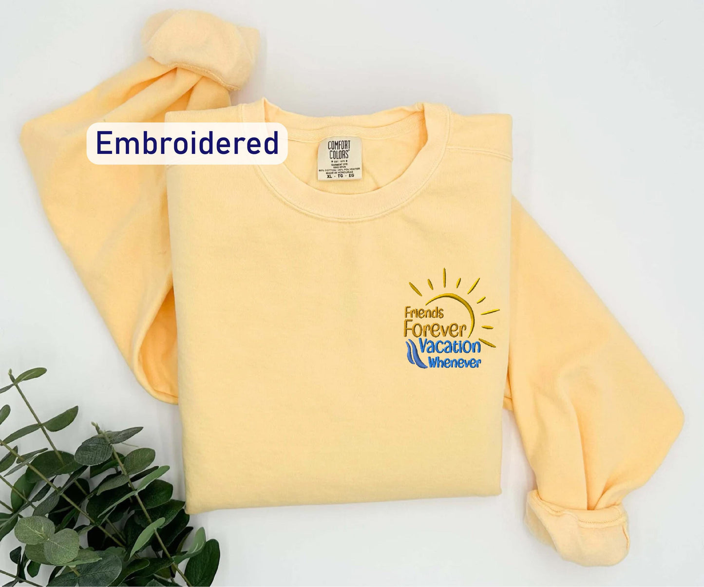 a yellow shirt with the words embroidered on it