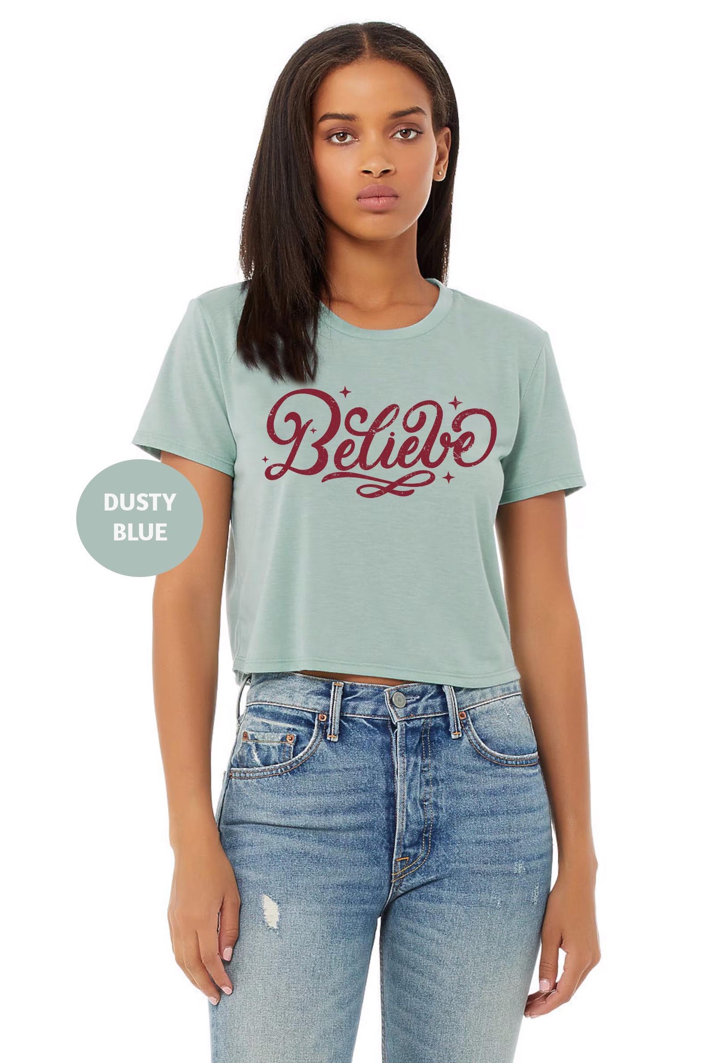 a woman wearing a t - shirt with the word believe on it