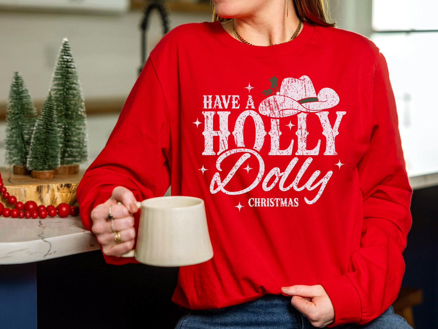 a woman in a red sweatshirt holding a coffee mug