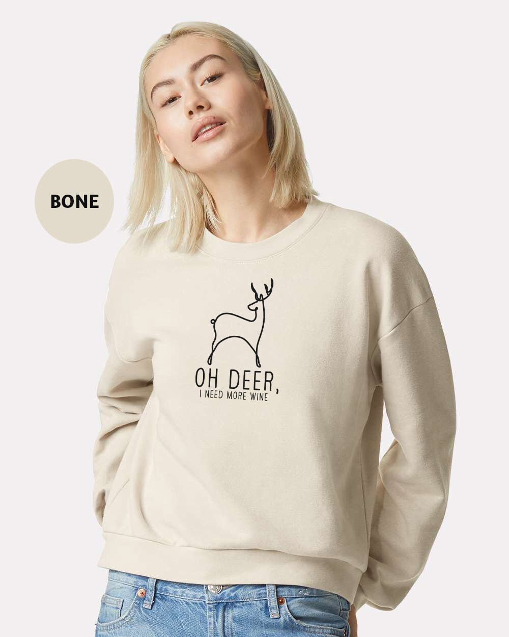 a woman wearing a sweatshirt with a deer on it
